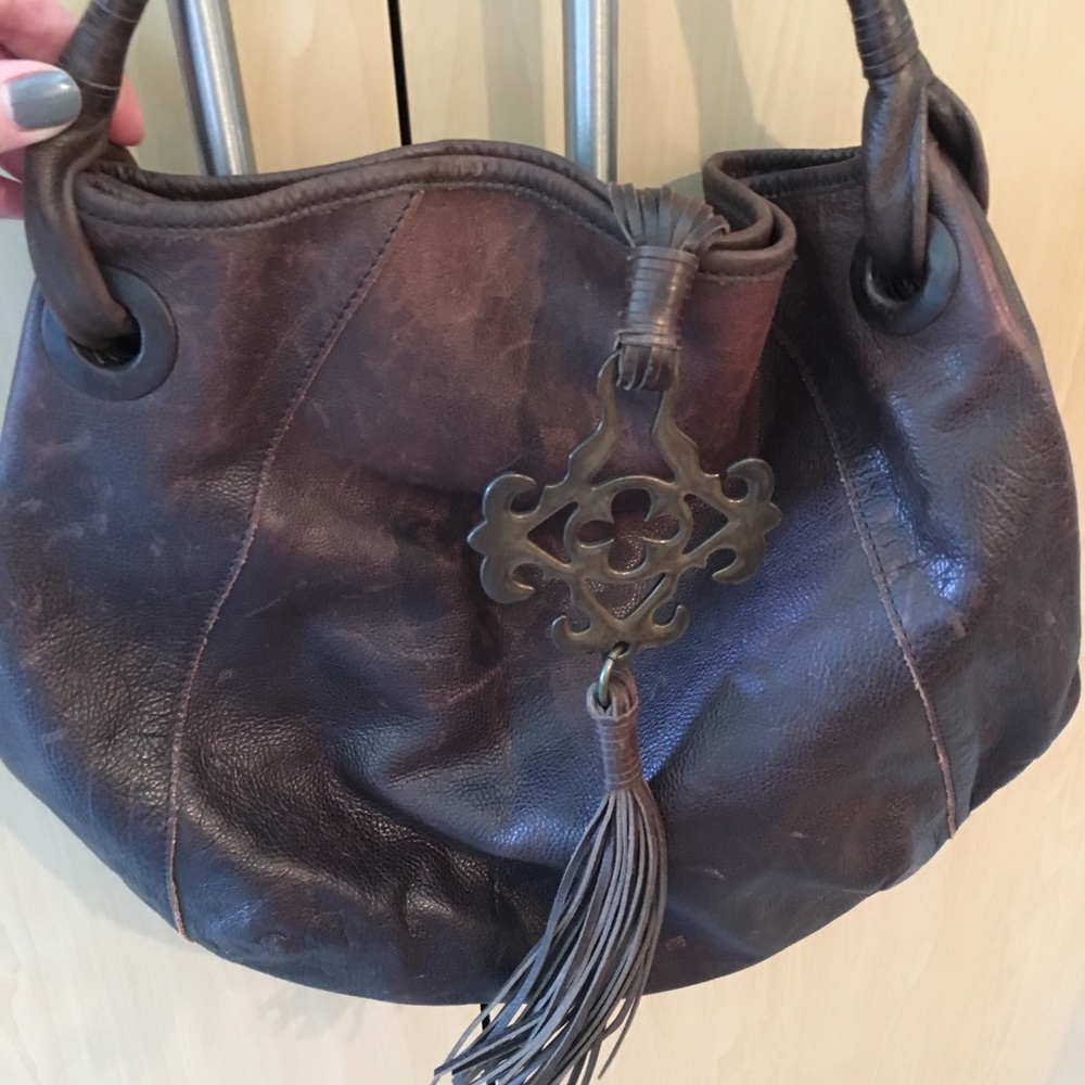 BCBG brown leather purse with metal emblem detail